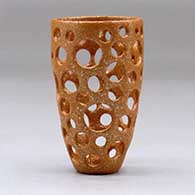 A small golden micaceous holey cylinder, click or tap to see a larger version