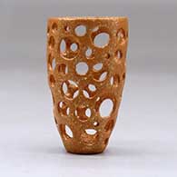 A small golden micaceous holey cylinder, click or tap to see a larger version