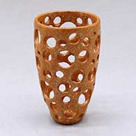 Click for a larger view A small golden micaceous holey cylinder
 by Hubert Candelario of San Felipe