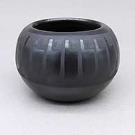 Small black-on-black bowl with a feather ring geometric design
 by Marvin and Frances Martinez of San Ildefonso