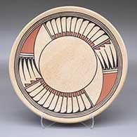 A polychrome plate decorated with a four-panel ring of feathers and geometric design
 by Johnny Cruz of San Ildefonso
