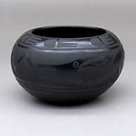 A black-on-black bowl decorated with an avanyu, rain cloud and geometric design
 by Marvin and Frances Martinez of San Ildefonso