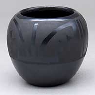 A black-on-black bowl decorated with an avanyu, rain cloud and geometric design above the shoulder
 by Marvin and Frances Martinez of San Ildefonso