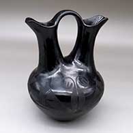 A black-on-black wedding vase with a four-panel geometric design
 by Maria Martinez of San Ildefonso