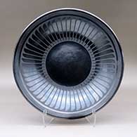 A black on black platter decorated with a ring-of-feathers design
 by Maria Martinez of San Ildefonso