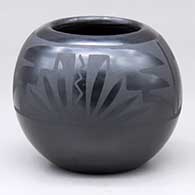 A small black on black jar decorated with a feather and geometric design
 by Marvin and Frances Martinez of San Ildefonso