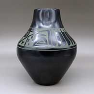 A large green on black jar decorated with a four-panel feather and geometric design around the shoulder, click or tap to see a larger version