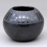 A black on black bowl decorated with a ring of feathers design around the body
 by Santana Martinez of San Ildefonso
