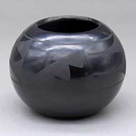 A black on black bowl decorated with a three-panel kiva step and geometric design
 by Santana Martinez of San Ildefonso