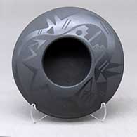 A black on black bowl decorated with an avanyu and pueblo design above the shoulder
 by Marvin and Frances Martinez of San Ildefonso
