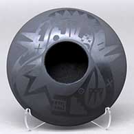 A black on black bowl decorated with an avanyu and pueblo design above the shoulder
 by Marvin and Frances Martinez of San Ildefonso