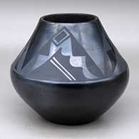 A black on black jar decorated with a four-panel geometric design above the shoulder
 by Maria Martinez of San Ildefonso