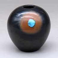 A black jar with a sienna spot and an inlaid stone
 by Dora Tse Pe of San Ildefonso