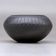 A black on micaceous black bowl decorated with a band of feathers above the shoulder, click or tap to see a larger version