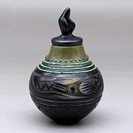 Click for a larger view A lidded polychrome jar decorated with a sgraffito avanyu and geometric design, inlaid strands of heishi beads and 26 inlaid stones
by Russell Sanchez of San Ildefonso