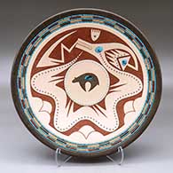 A polychrome plate decorated with a sgraffito, slipped and painted avanyu, cloud, bear and geometric design with bands of inlaid heishi beads, multiple inlaid stones and three inlaid pieces of turquoise
 by Russell Sanchez of San Ildefonso