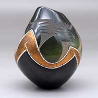 A polychrome jar with an organic opening and shape decorated with a sgraffito duck and bullrushes with inlaid strands of heishi beads and a geometric design, click or tap to see a larger version