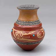 A small polychrome jar with a recurved neck, micaceous notched rim, inlaid stones and strands of heishi beads with a sgraffito avanyu and geometric design around the shoulder
 by Russell Sanchez of San Ildefonso