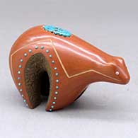 A small red bear figure decorated with inlaid stones and a sgraffito geometric design
 by Russell Sanchez of San Ildefonso