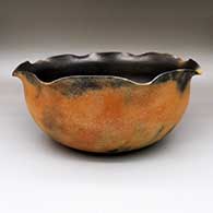 A golden micaceous grandmother bowl with fire clouds, a pie crust rim and a blackened interior
 by Angie Yazzie of Taos