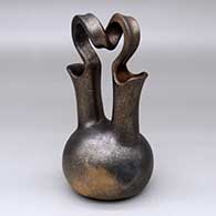 A golden micaceous wedding vase with heavy fire clouds and a spiral bridge
 by Eric Marcus of Taos