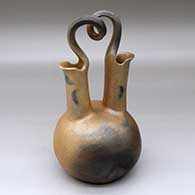 A golden micaceous wedding vase with fire clouds and a looped bridge
 by Eric Marcus of Taos