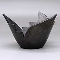 A stylized micaceous black prayer bowl, click or tap to see a larger version