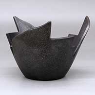 A stylized micaceous black prayer bowl, click or tap to see a larger version
