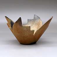 A stylized golden micaceous prayer bowl decorated with fire clouds, click or tap to see a larger version