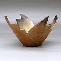 A stylized golden micaceous prayer bowl decorated with fire clouds, click or tap to see a larger version