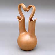 A golden micaceous wedding vase with a looped bridge
 by Eric Marcus of Taos