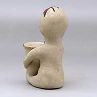 A polychrome Tesuque rain god figure with a pot, click or tap to see a larger version