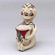 A polychrome Tesuque rain god figure with a pot
 by Unknown of Tesuque