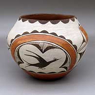 A polychrome jar decorated with a two-panel roadrunner, rainbow, cloud pattern and geometric design
 by Seferina Bell of Zia