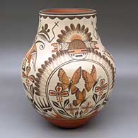 A large polychrome jar decorated with a four panel hummingbird, butterfly, moth, flower, bird element and geometric design
 by Marcellus Medina of Zia