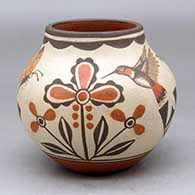 A small polychrome jar decorated with a two panel hummingbird, butterfly, flower and geometric design
 by Marcellus Medina of Zia