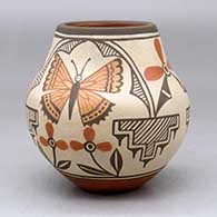 A small polychrome jar decorated with a four panel hummingbird, butterfly, flower and geometric design
 by Marcellus Medina of Zia