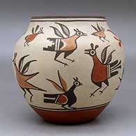 A polychrome jar decorated with images of roadrunners from throughout Zia pottery history, click or tap to see a larger version