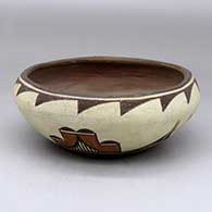 An open polychrome bowl decorated with a four panel cloud and geometric design
 by Unknown of Zia