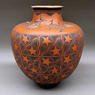 A large polychrome jar decorated with bands of stars, katsinas and geometric design
 by Anderson Jamie Peynetsa of Zuni