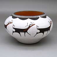 A polychrome jar decorated with a band of deer-with-heart-line and geometric design
 by Anderson Peynetsa of Zuni