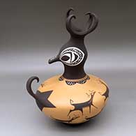 A polychrome duck pot decorated with a bird element, deer-with-heart-line and geometric design
 by Anderson Peynetsa of Zuni