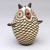 A polychrome owl figure decorated with a bird element and geometric design
 by Carlos Laate of Zuni