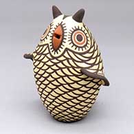 A polychrome owl figure decorated with a bird element and geometric design
 by Carlos Laate of Zuni