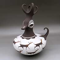 A polychrome duck pot with a feathered crest and decorated with a deer-with-heart-line and geometric design
 by Anderson Peynetsa of Zuni