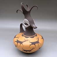 A polychrome duck pot with a deer-with-hart-line and geometric design plus a feathered crown
 by Anderson Peynetsa of Zuni