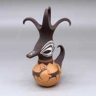 A small polychrome duck pot with a feathered crown and decorated with a deer-with-heart-line and geometric design
 by Anderson Peynetsa of Zuni