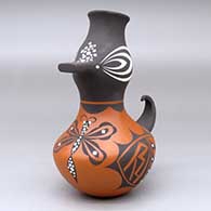 A small polychrome duck pot decorated with a dragonfly, bird element and geometric design
 by Anderson Jamie Peynetsa of Zuni