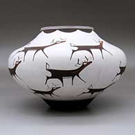 A polychrome jar decorated with a deer-with-heart-line and geometric design, click or tap to see a larger version