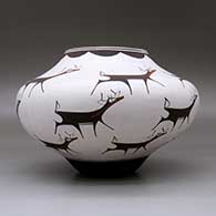 A polychrome jar decorated with a deer-with-heart-line and geometric design, click or tap to see a larger version